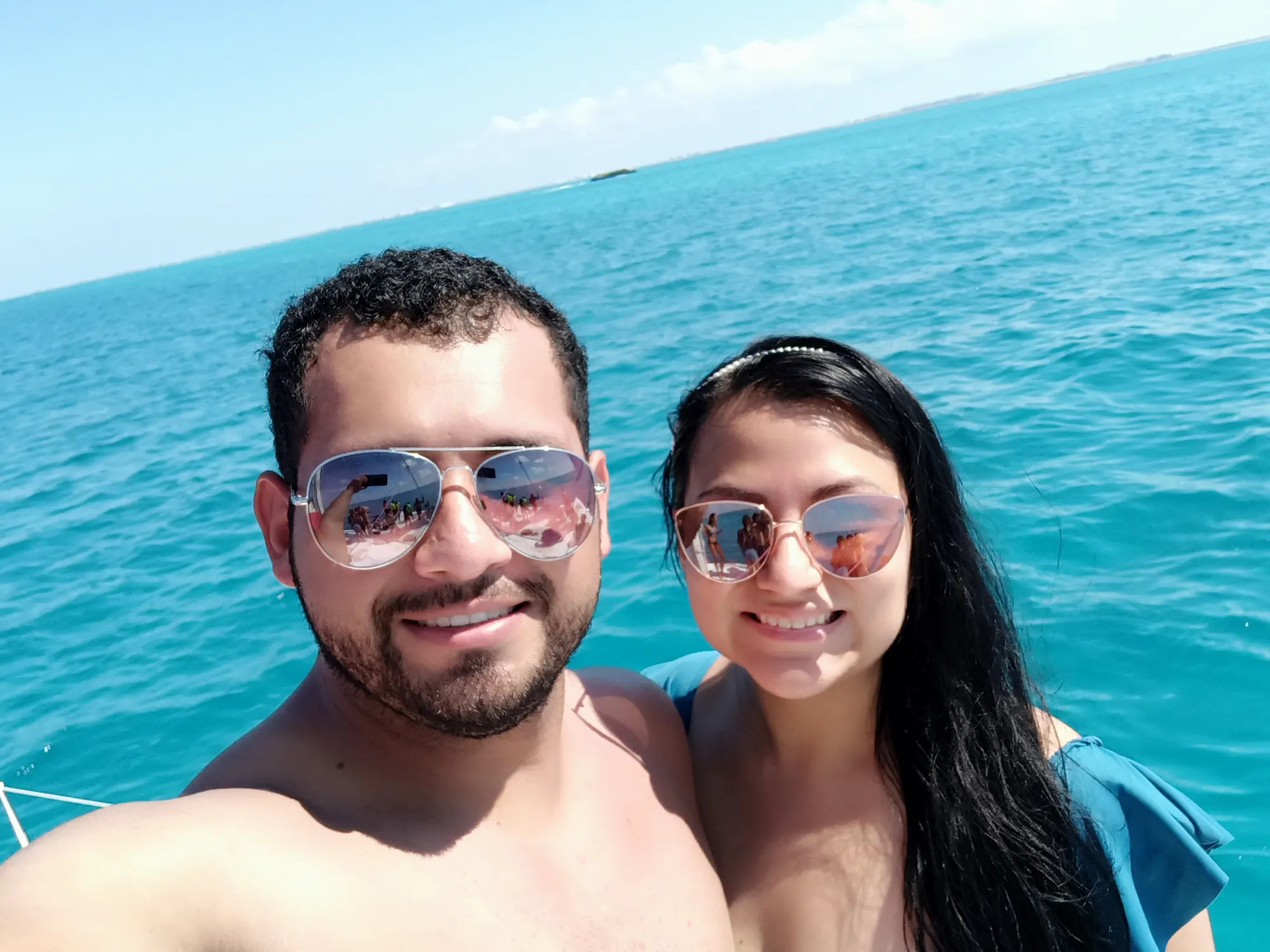 a man and woman taking a selfie in the water