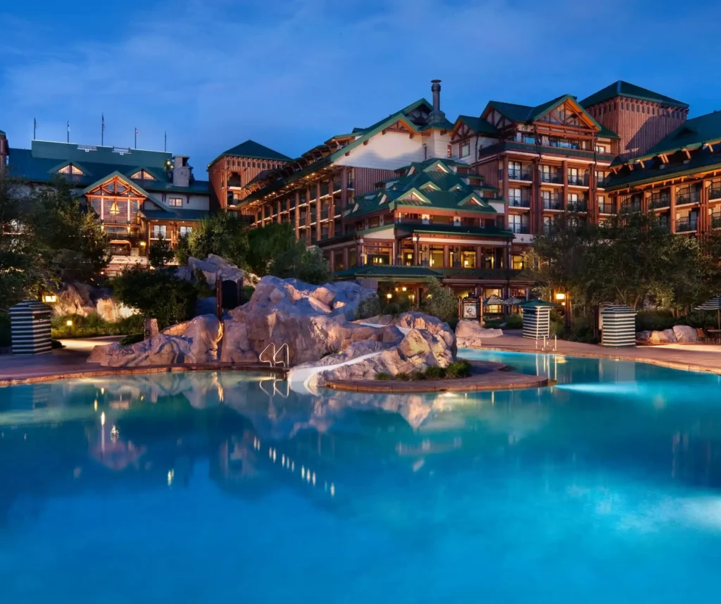 a pool with Disney's Wilderness Lodge in the background