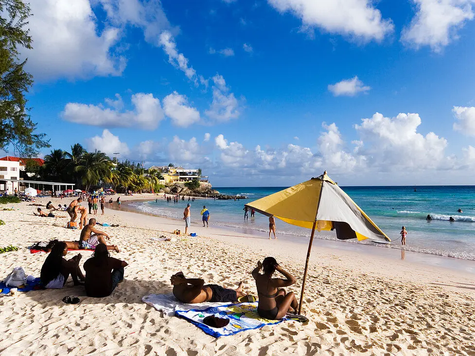 people on a beach with people sunbathing and sunbathing